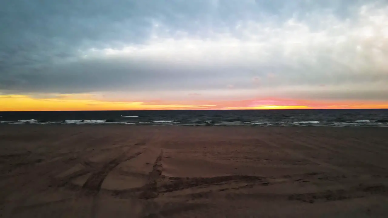 Rising over the sandy beaches of Michigan during a fall sunset