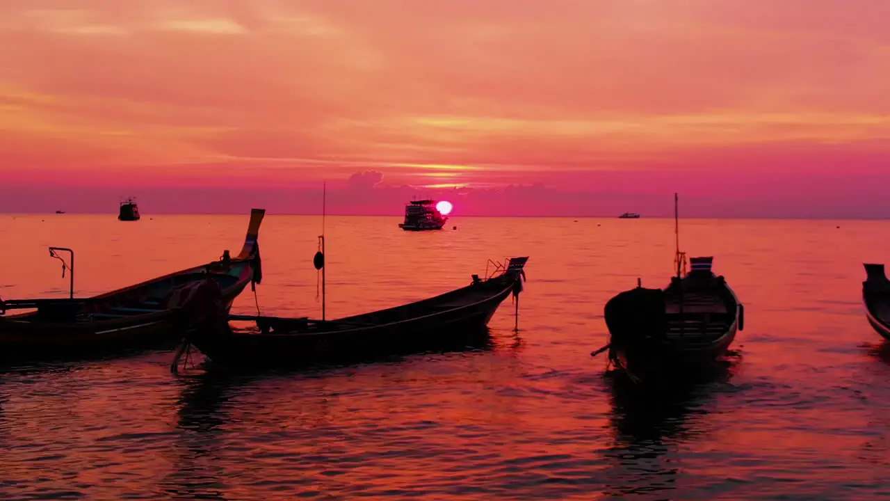 Aerial shot of Koh Tao island Super sunset at Sairee Beach with many boats floating Thailand