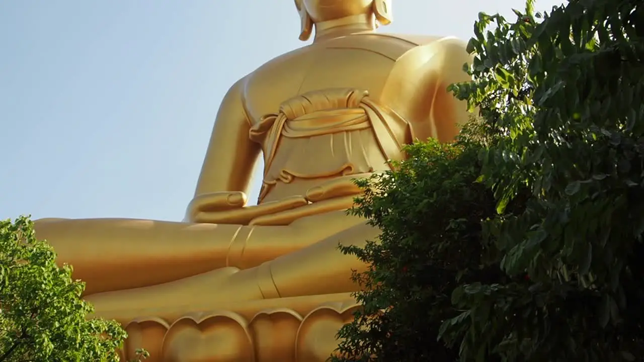 Golden Big Buddha at the temple Wat Paknam Bangkok Thailand blue sky