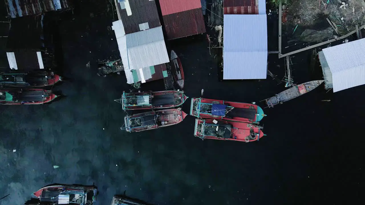 Fishing village boats moored by housing in South East Asia