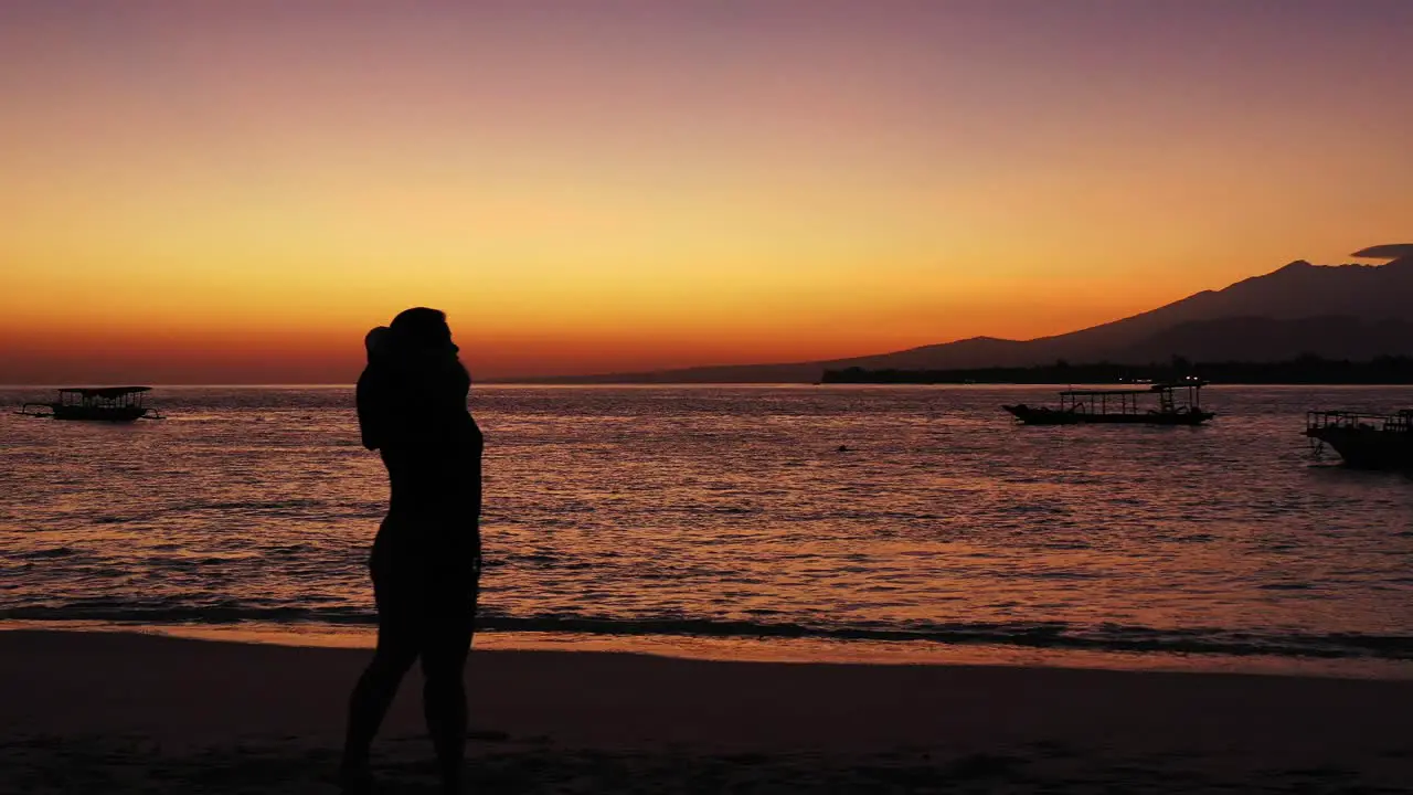 philippines worried woman with the hands on her hand standing on the sandy beach during the sunset