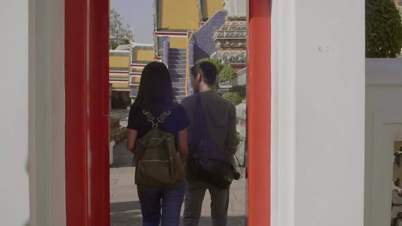 Couple Walking Through Red Doorway