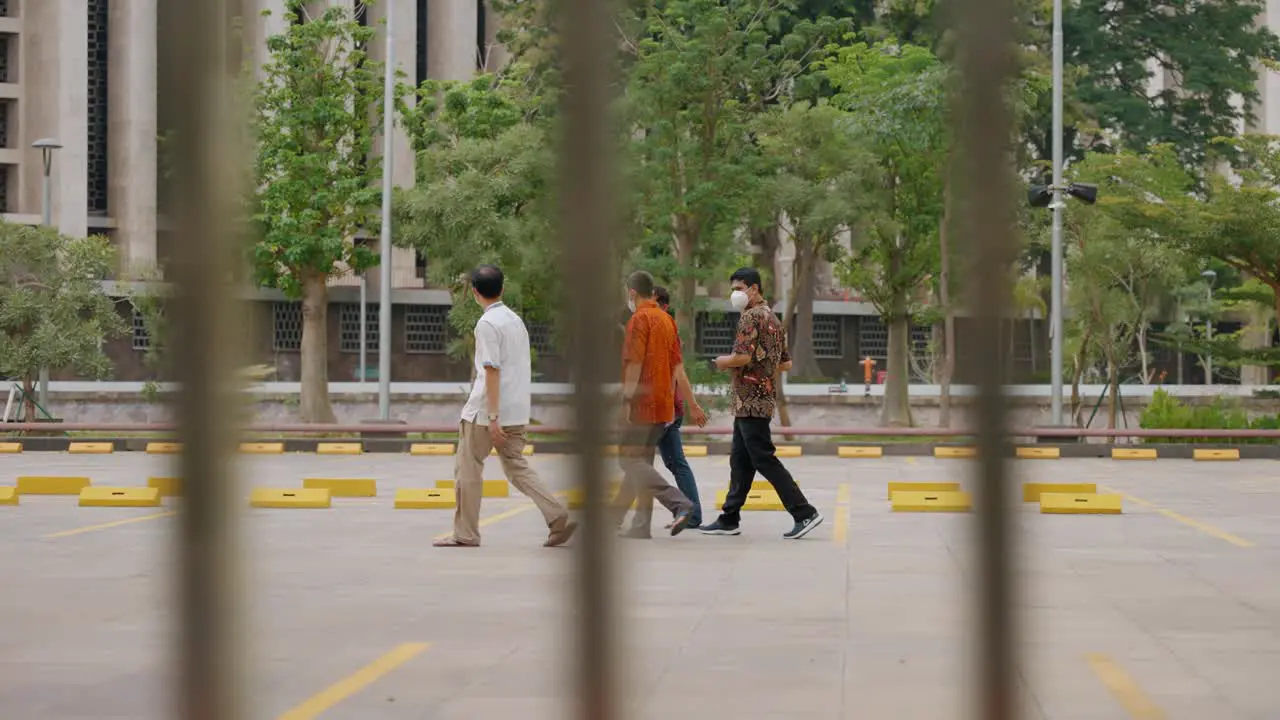 Tracking Shot of Men Walking Through Jakarta