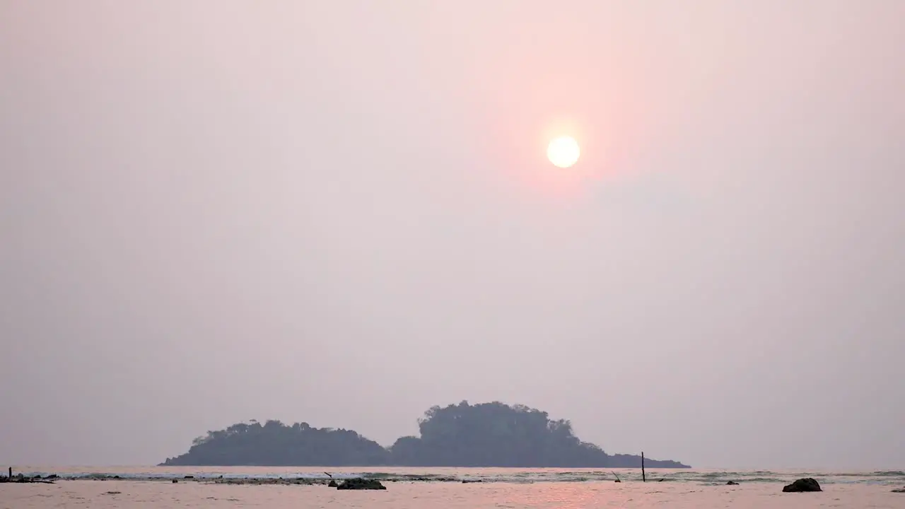 Hazy Sunset Over Ocean And Hills