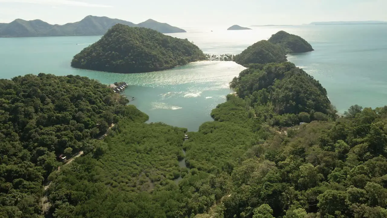 4k drone footage wide angle of beautiful tropical islands with mangroves and beach and small resort in distance