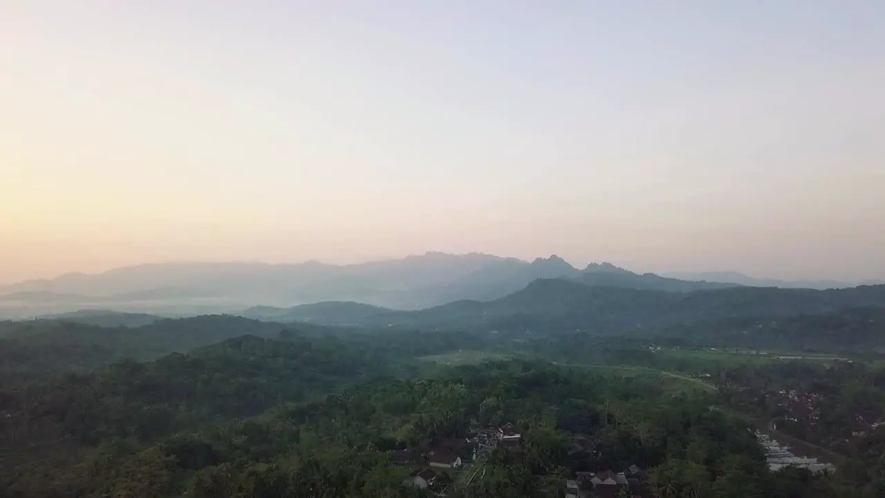 Aerial flyover idyllic mountain landscape during mystic foggy morning