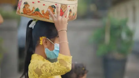 Tracking Shot of Young Girl Carrying Things Through Bali