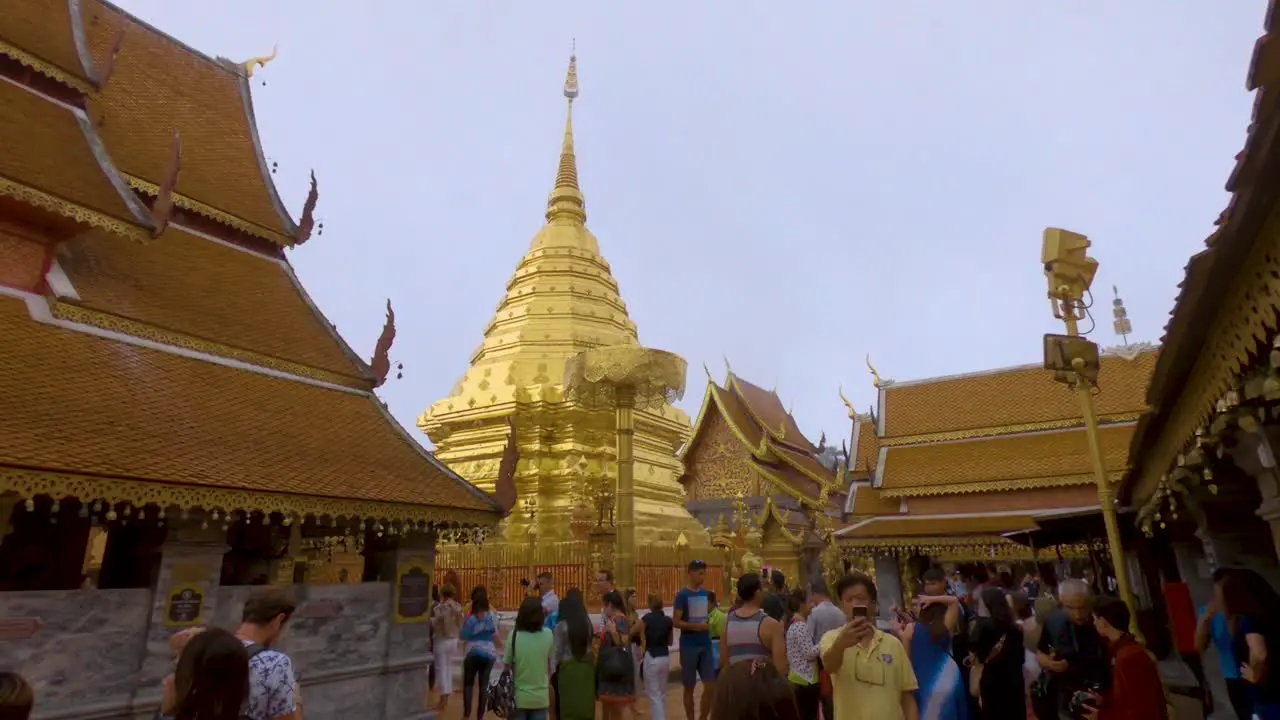 Exploring the Wat Phrathat Doi Suthep temple tour guides show people around the golden structures