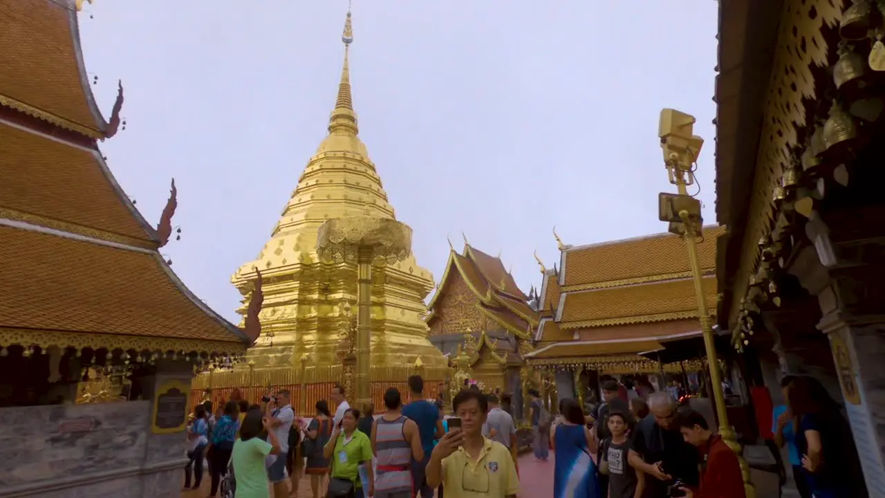 Tour guides show people around the golden Wat Phrathat Doi Suthep temple