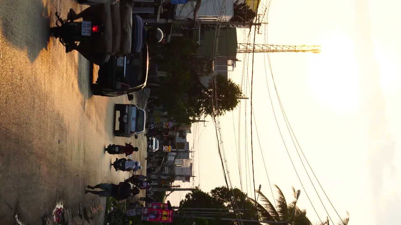 VERTICAL PhanThiet vietnam city village in asia with scooter driving around during golden hours