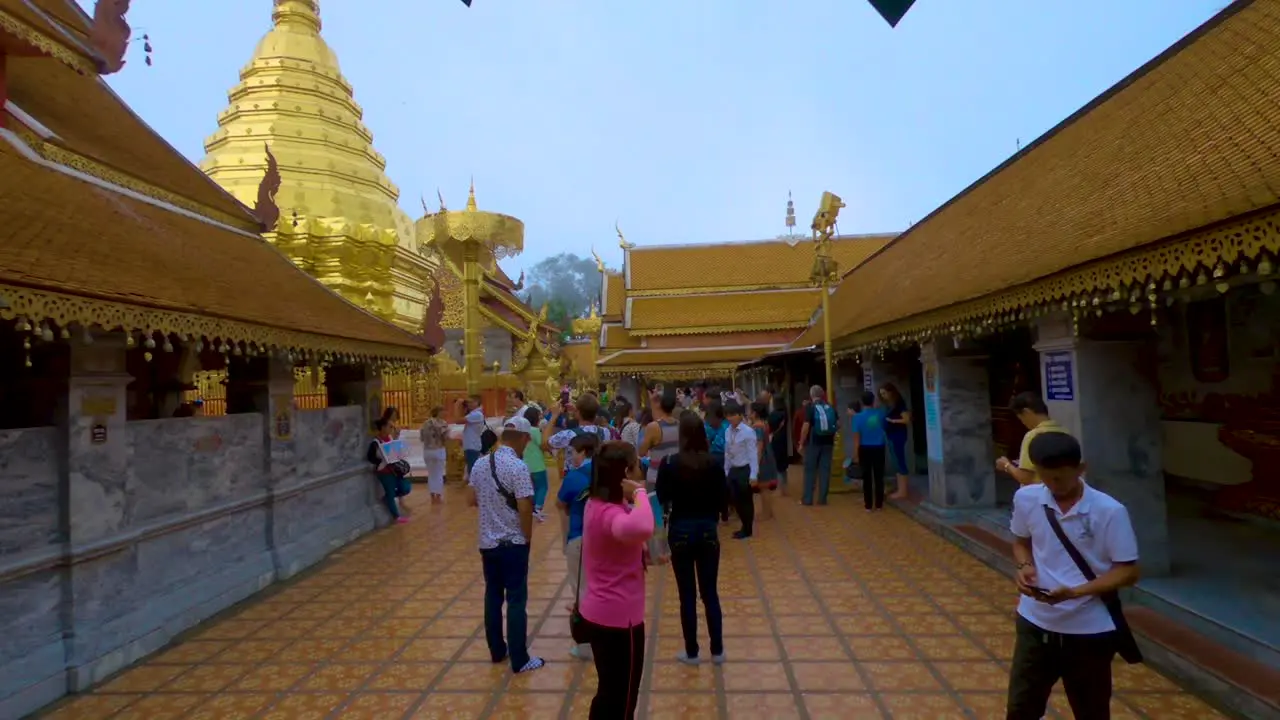 Exploring the Wat Phrathat Doi Suthep temple where tour guides show people around the golden structures