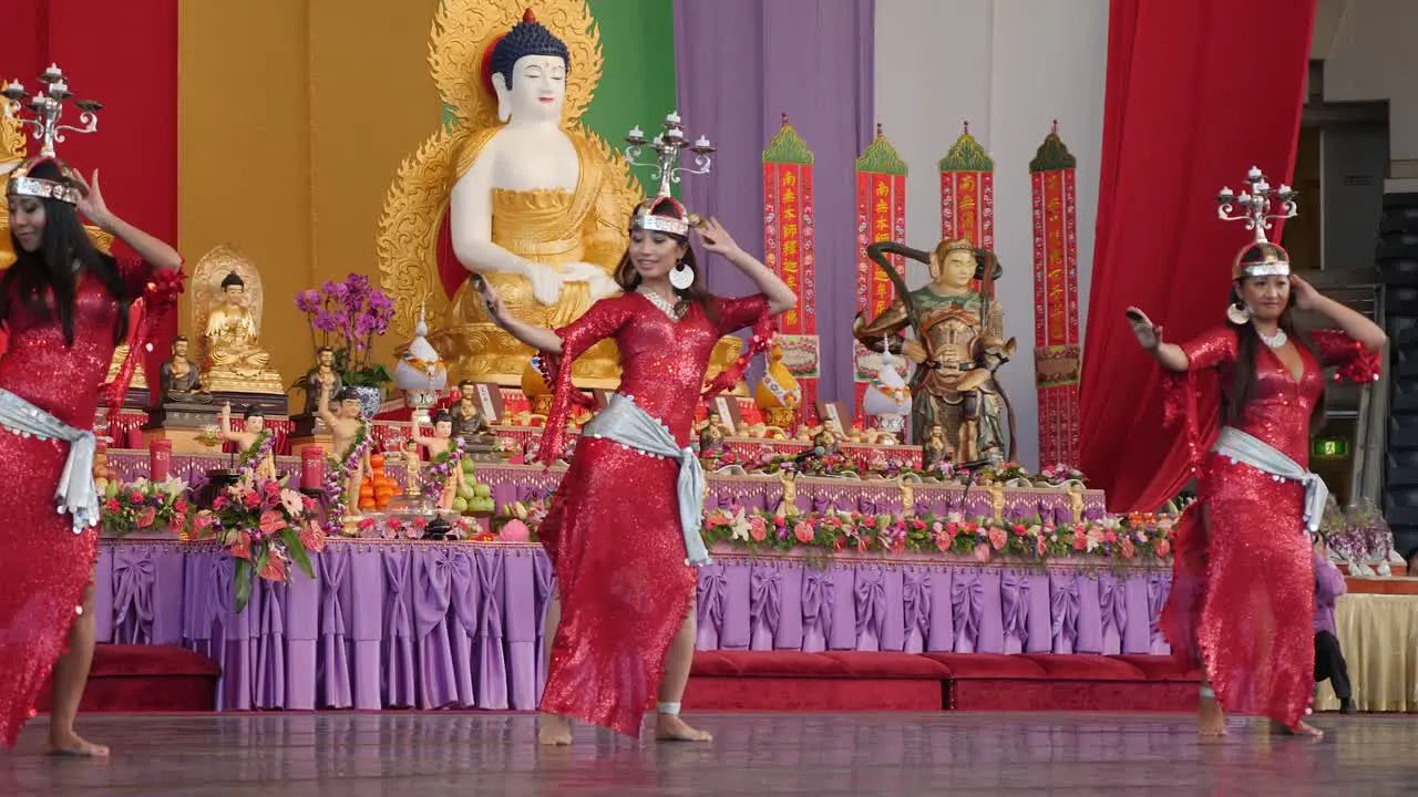 Indonesian women dancing belly dance with candle holder on head during Buddha Birthday Festival Brisbane 2018