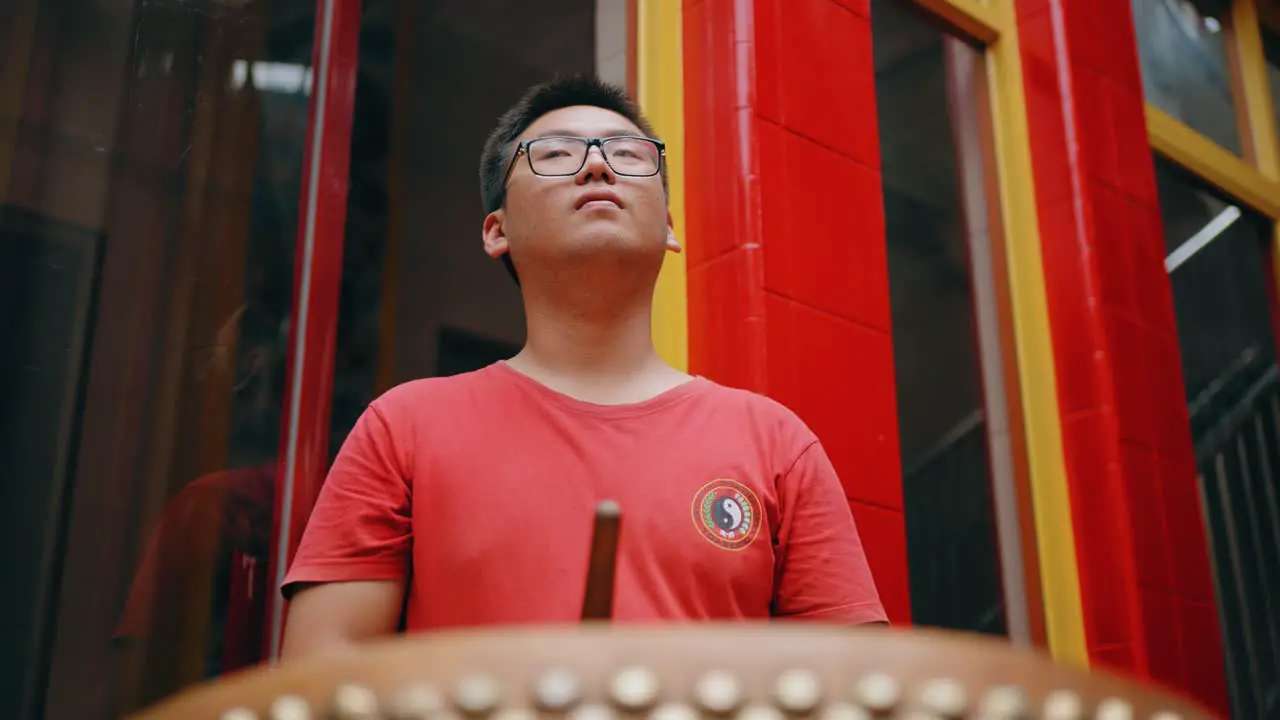 Low Angle Shot of a Boy Playing Drum in Jakarta