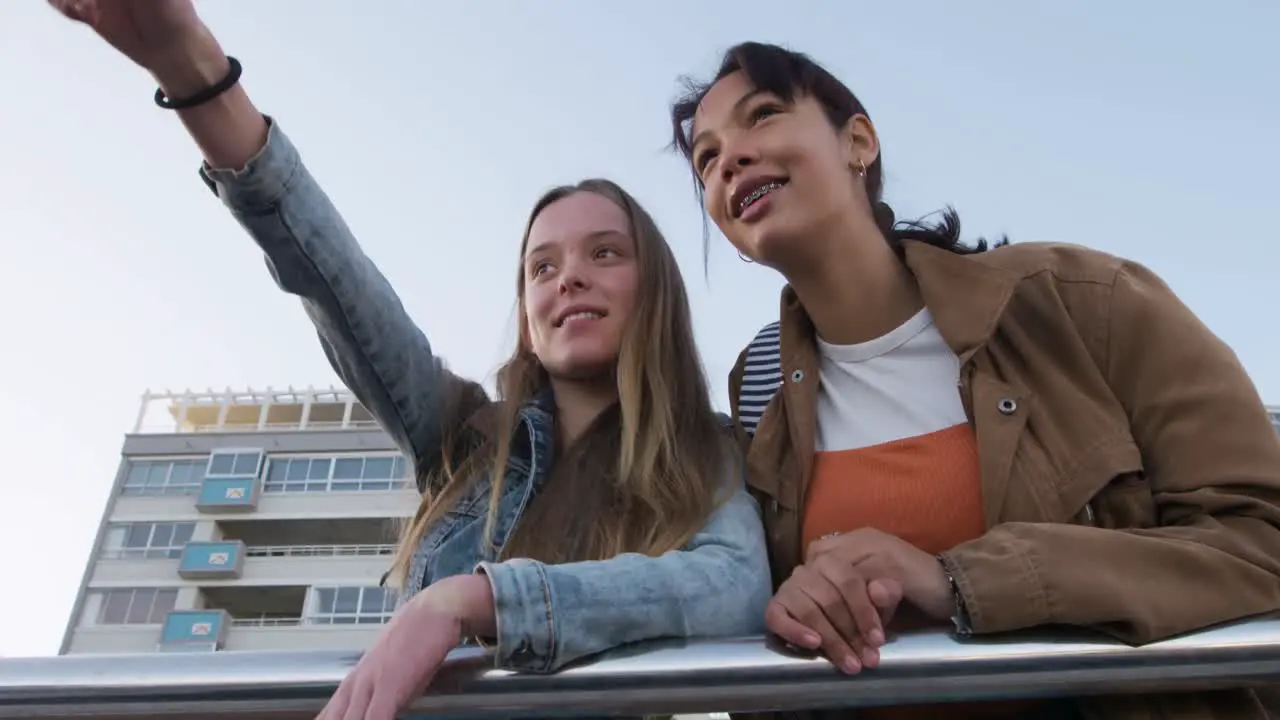 Low angle of a Caucasian and a mixed race girl enjoying the view