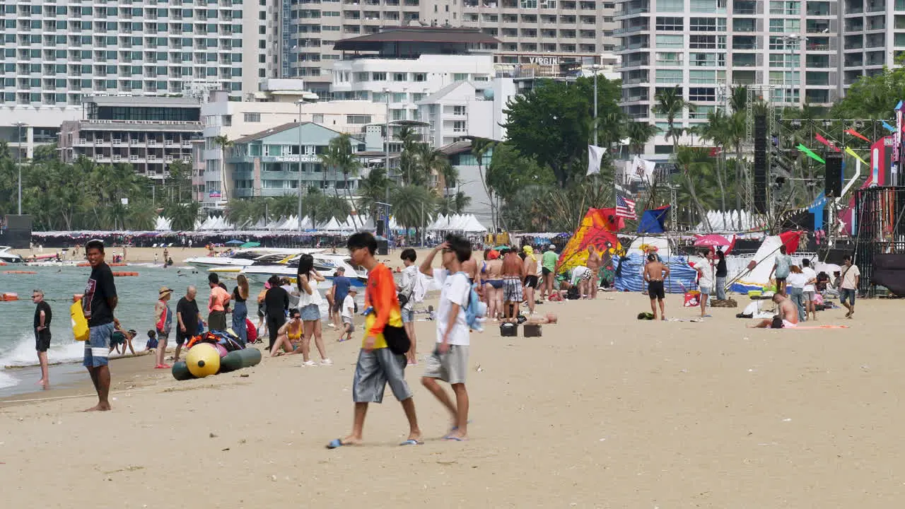 Local and foreign tourists are strolling sunbathing and taking pictures at beachfront of Pattaya in the province of Chonburi in Thailand