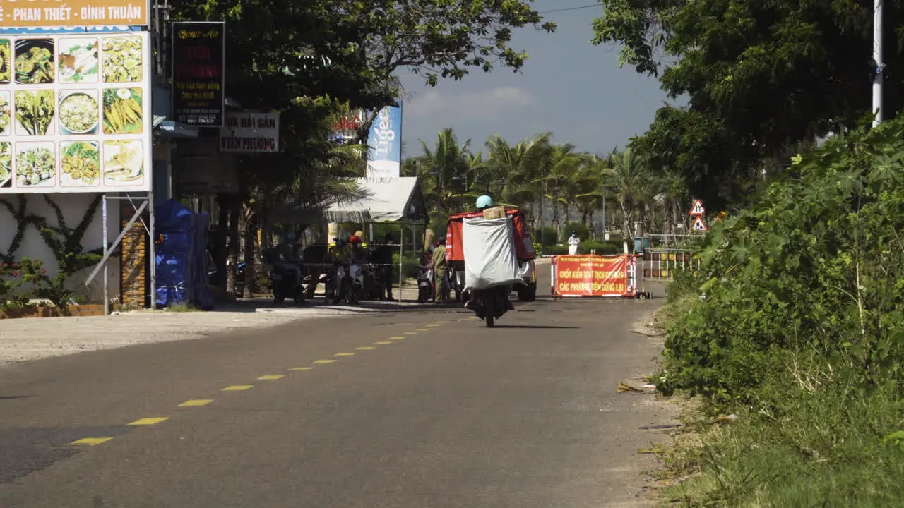 Person driving motor bike in Vietnam reaching COVID roadblock between Mui Ne and Ham Tien