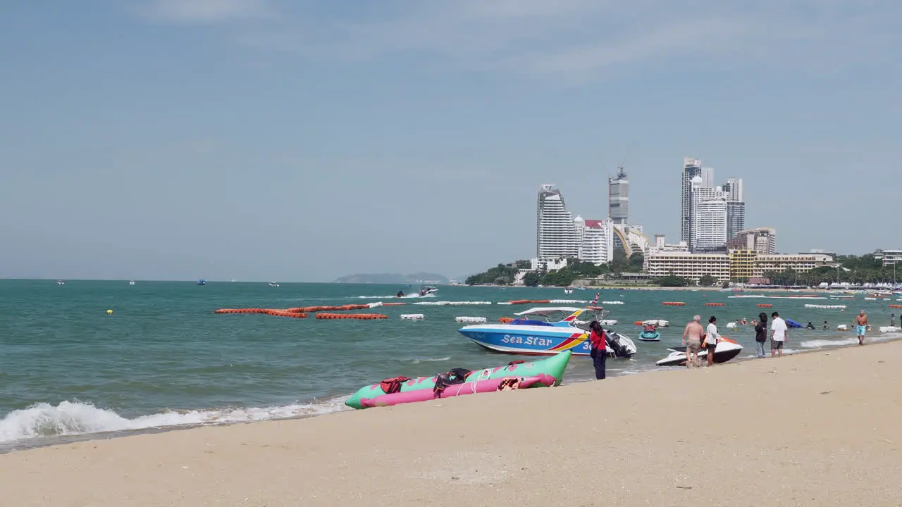 Local and foreign tourists are strolling taking pictures and jet skiing at the beachfront of Pattaya Beach in Chonburi province in Thailand