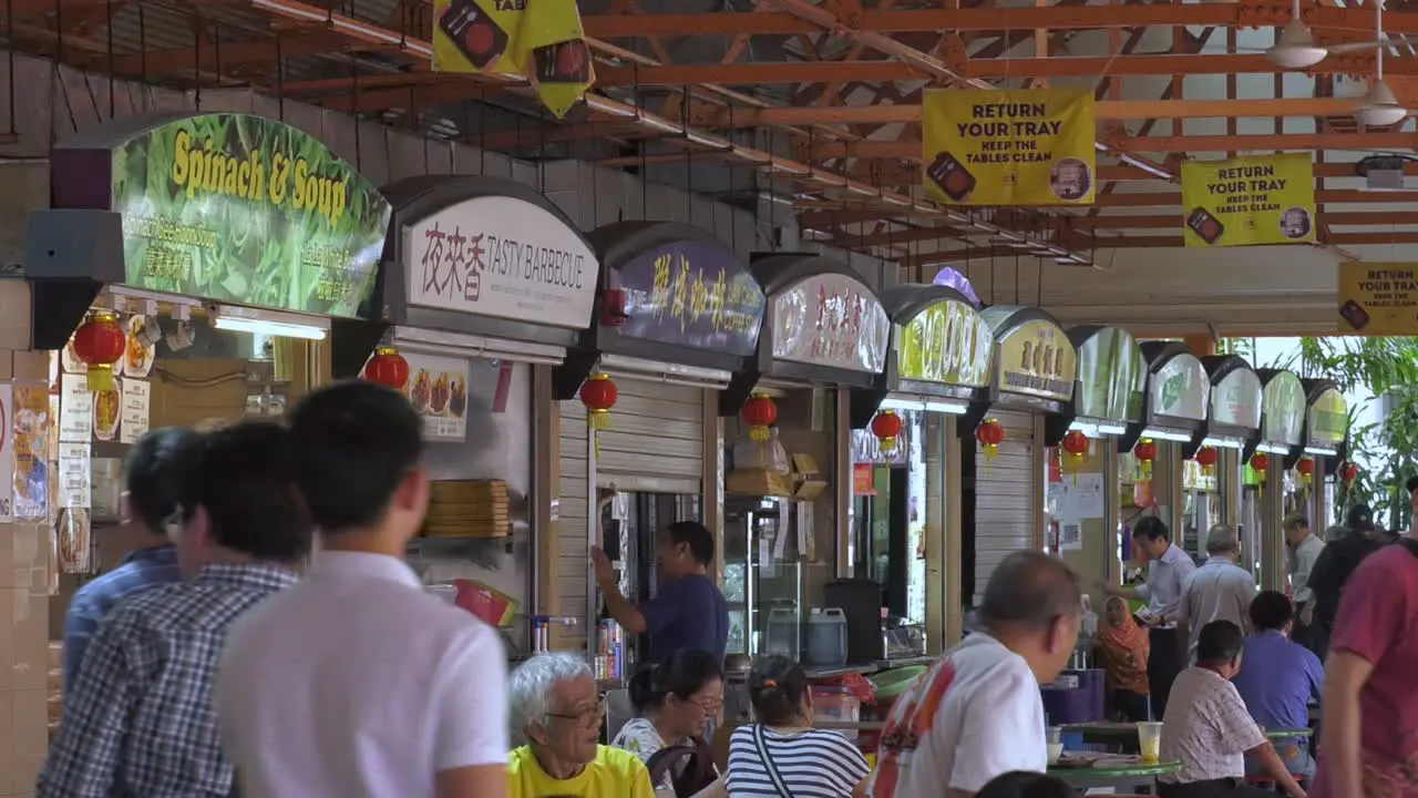 Busy Hawker Food Centre in the middle of business district Singapore Wide static shot