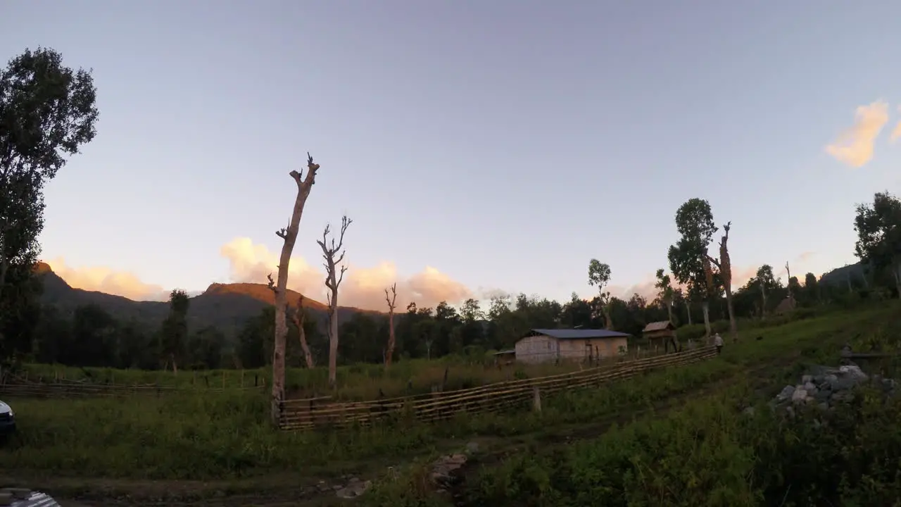 Timelapse of clouds moving over East Timor village while the evening is falling