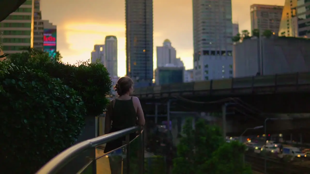 A Beautiful Young Woman Enjoying Cityscape Views In Bangkok Business District And City Center