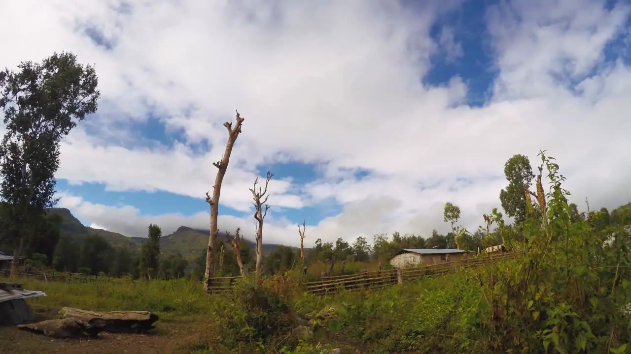 TImelapse of clouds moving over the hills in East Timor while people walking around