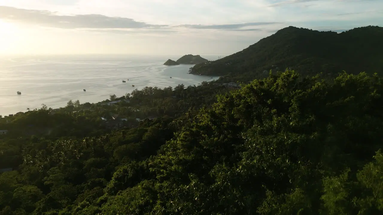 drone taking off from jungle revealing amazing sunset over the highlands of koh tao thailand south east asia travel destination