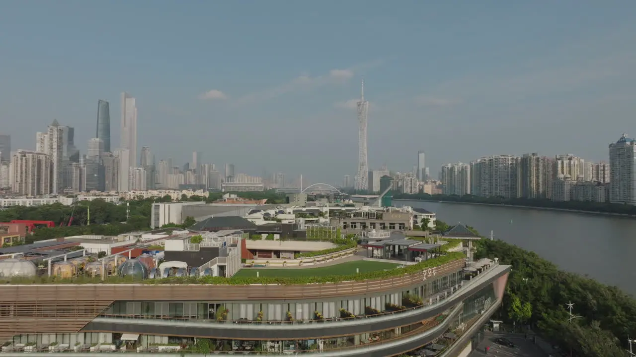 Aerial of the top of a Condo as the drone flies forwards towards downtown Guangzhou city China