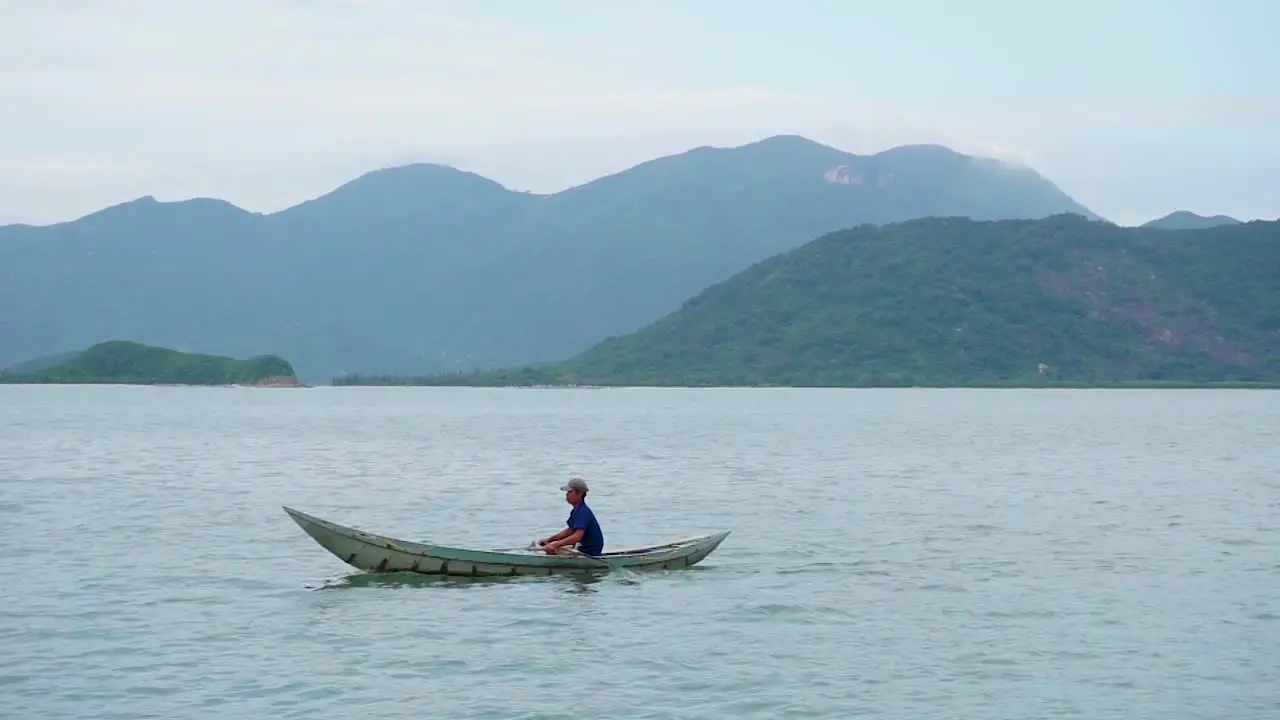 Local vietnamese man ride small boat off the coast of Nha Trang