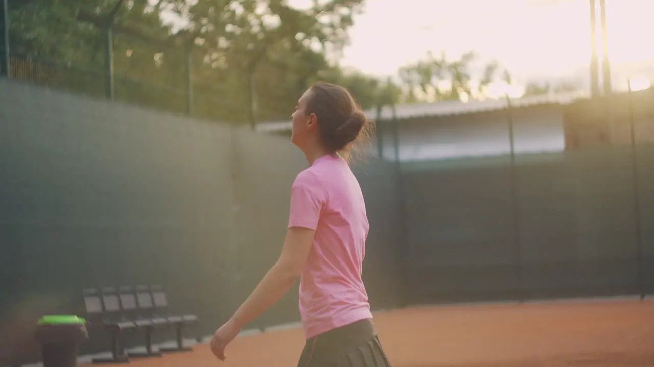 Tired female tennis player on the court tired getting ready in the sun in slow motion