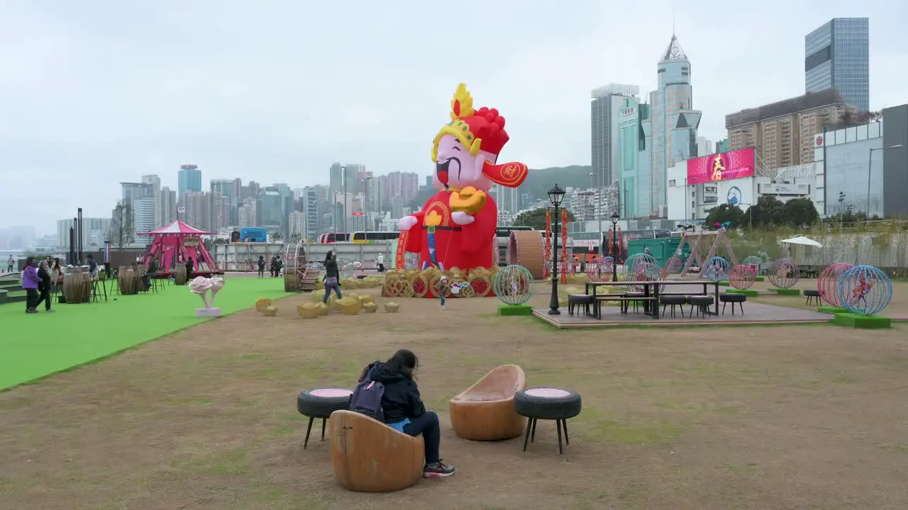 An outdoor Chinese New Year theme installation event for the Chinese Lunar New Year as skyscrapers are seen in the background in Hong Kong