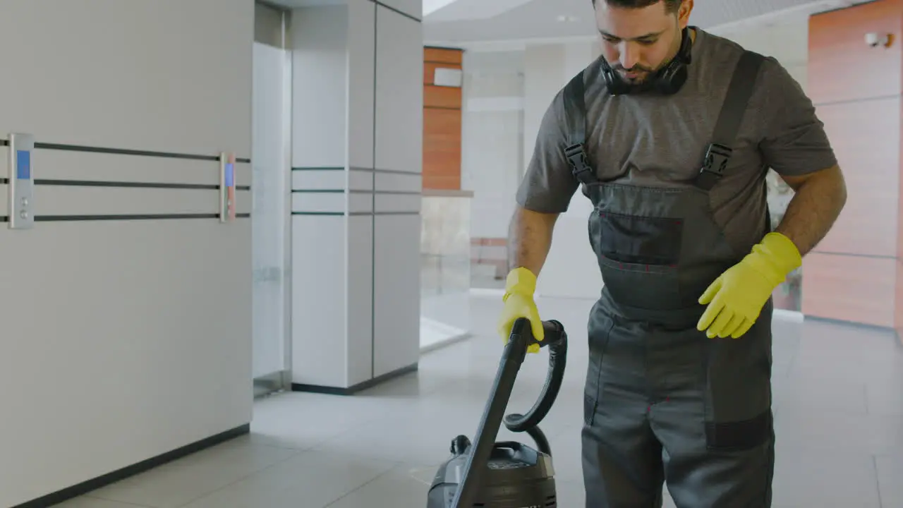 Arabic Cleaning Man Cleaning With Pressure Water Machine Inside An Office Building