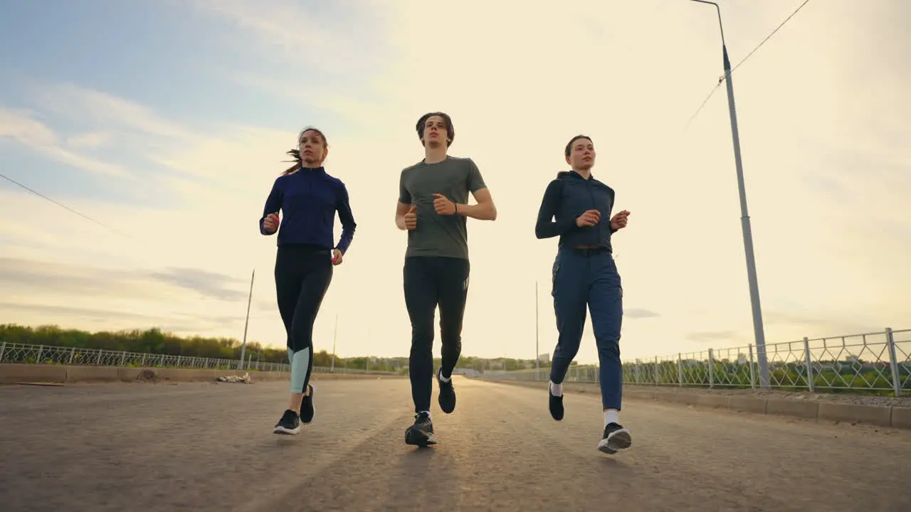 group of three joggers are running in morning training before marathon professional sport