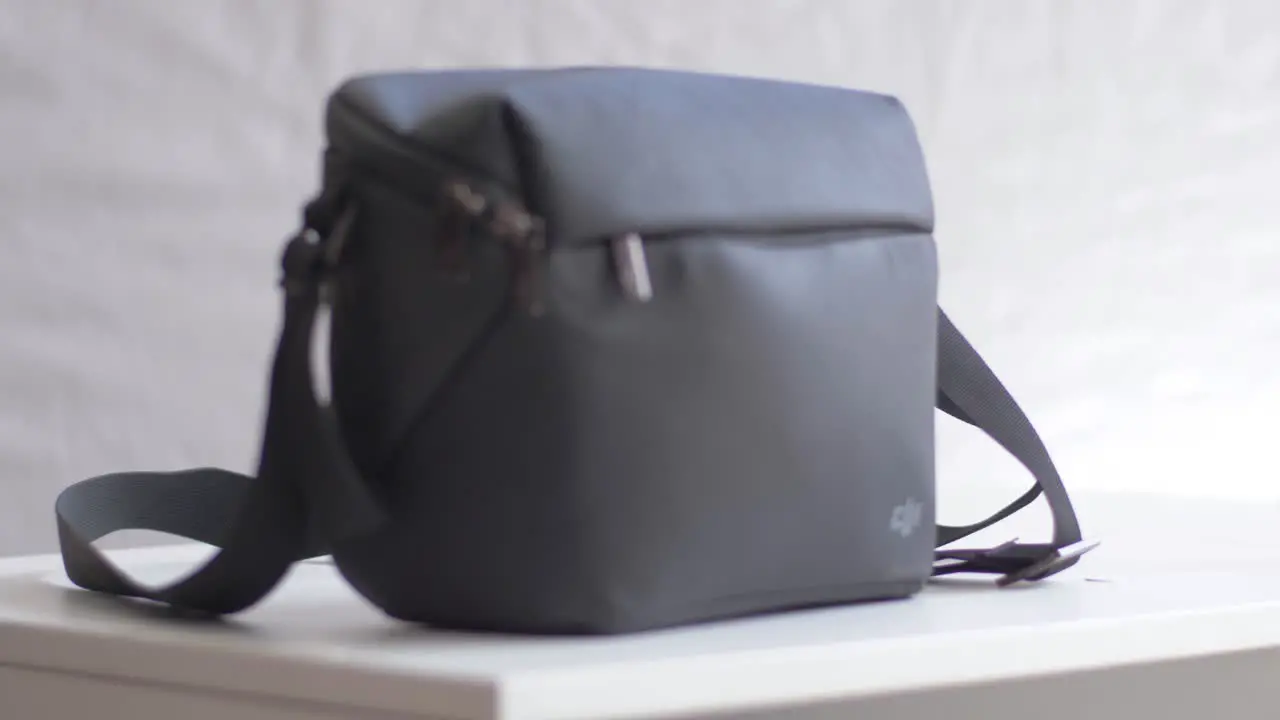 The DJI Mini 2 bag is placed on a white table with a rear to front focus