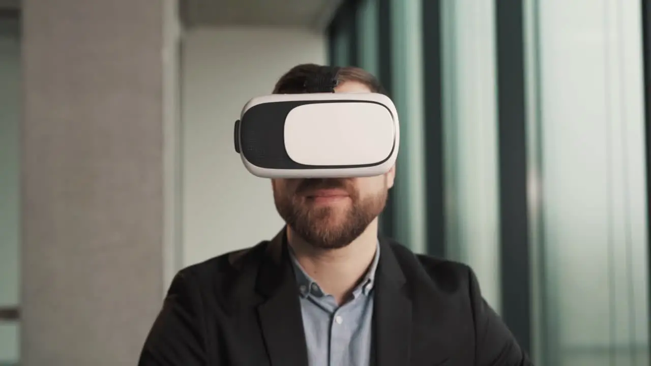 lose-up portrait of a handsome adult man in eyeglasses wearing a virtual reality headset in an immersive digital environment