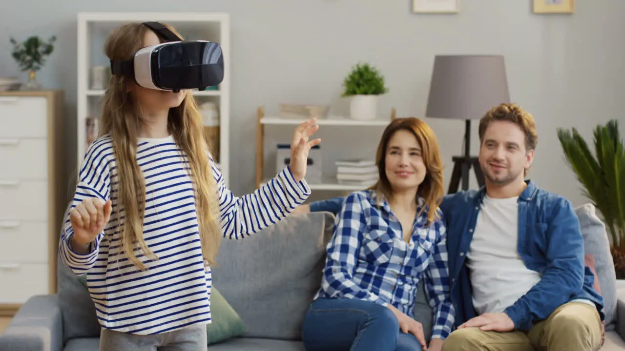 Small Cute Blonde Girl In The Vr Glasses Having A Vr Headset In The Living Room