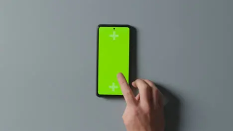 Overhead Studio Shot Of Man Using Green Screen Mobile Phone 1