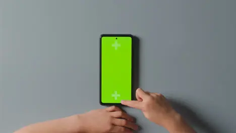 Overhead Studio Shot Of Man Using Green Screen Mobile Phone 3