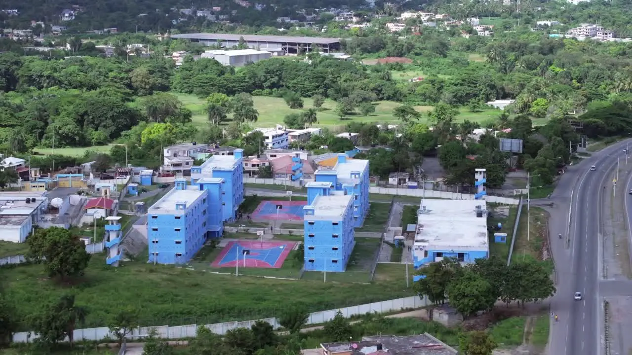 Sideways aerial of big cell blocks of a Jail in the Caribbean Dominican republic