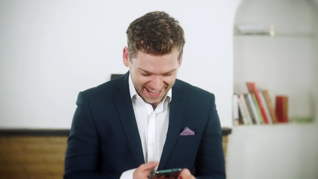 Handsome young businessman is using an app on his phone