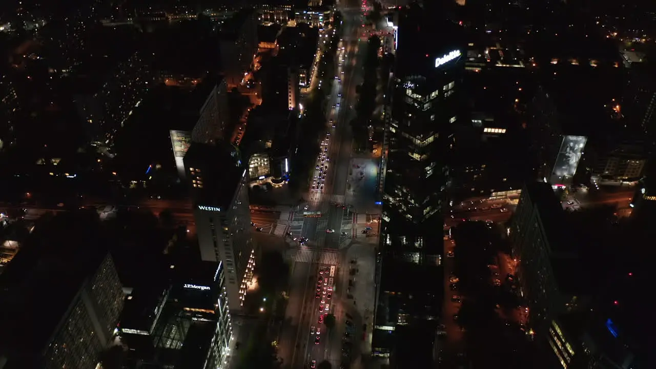 High angle view of road intersection in night city Cars driving through crossroad Tilt down to top down view Warsaw Poland