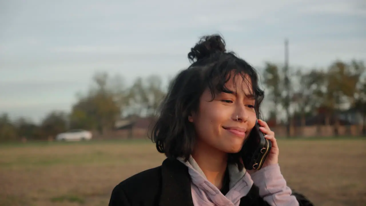 Asian woman listening on her mobile cellphone and nodding