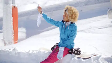 Happy young woman posing for a winter selfie