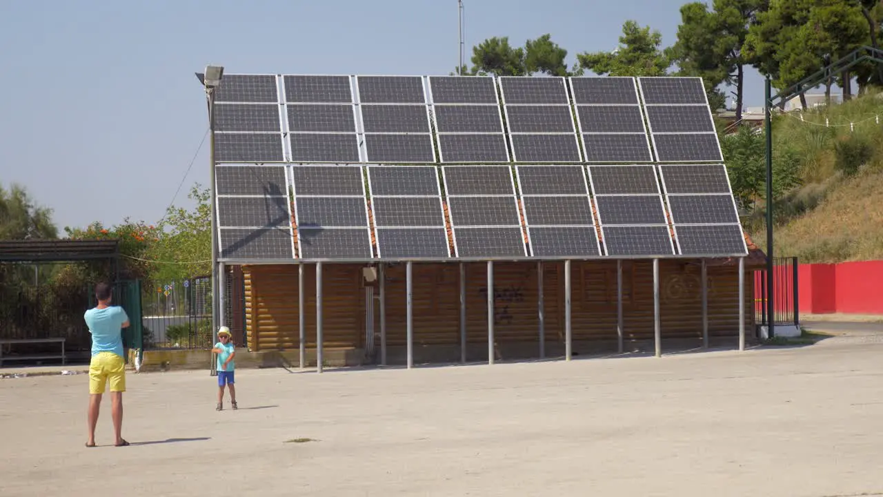 In city Perea Greece father photographed his son near solar panels