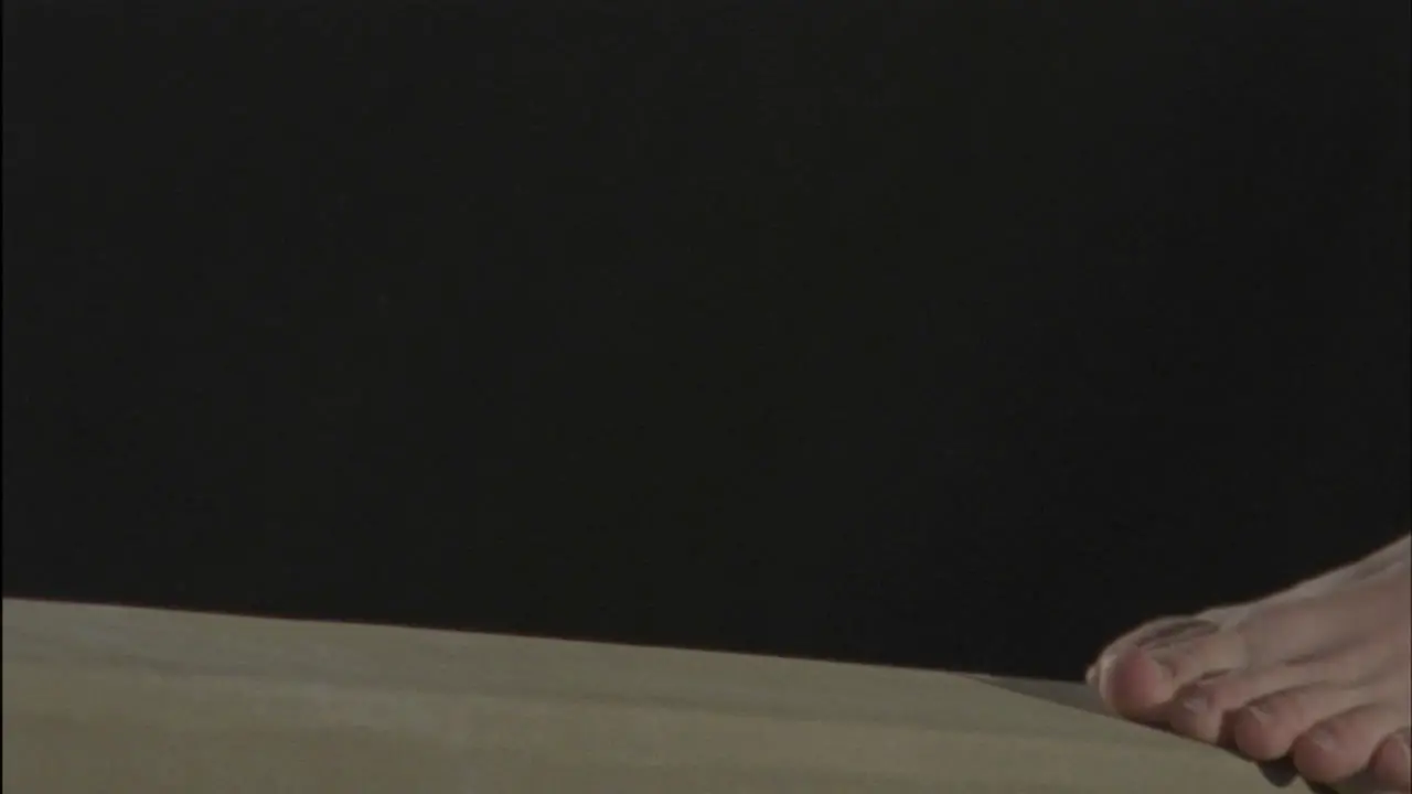 A female gymnast performs on a balance beam