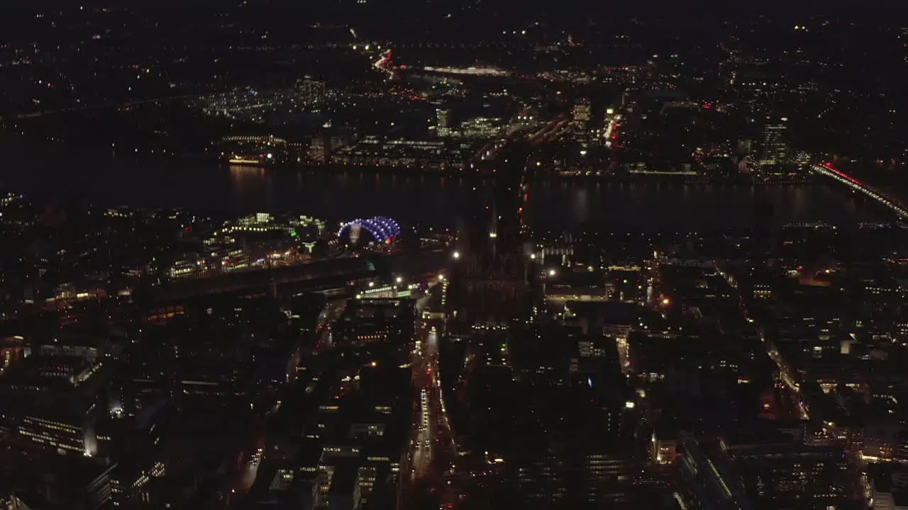 AERIAL Beautiful Wide Shot over Cologne Germany at Night time with City lights