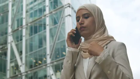 Muslim Businesswoman On Mobile Phone Standing Outside Office In City 5