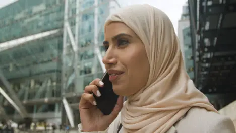 Muslim Businesswoman On Mobile Phone Standing Outside Office In City 7