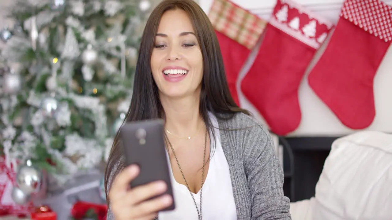 Happy young woman taking a selfie at Christmas