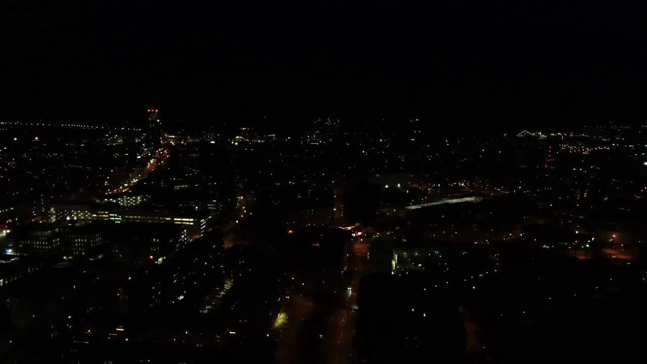 Flying over city lights in dark night