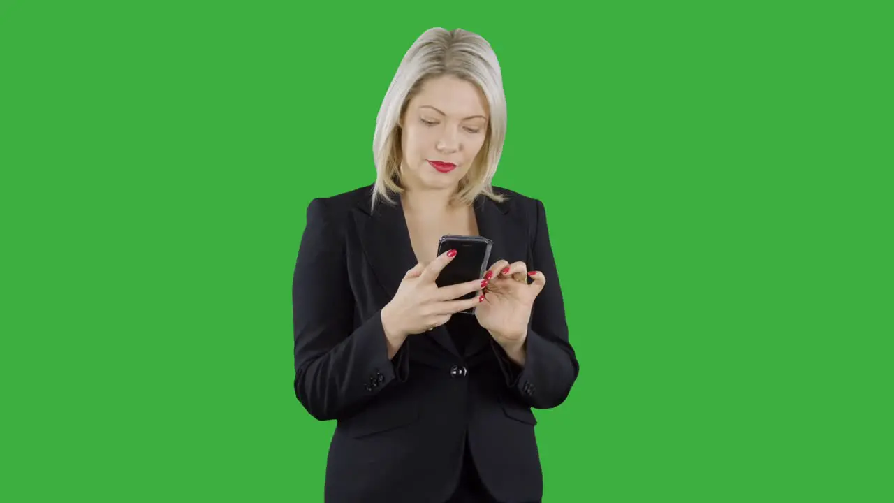 An attractive happy blonde haired businesswoman is using an app on her mobile cell phone